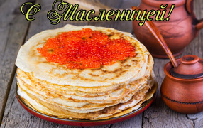 Thin pancakes with red caviar on the table for the holiday Maslenitsa