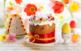 Beautiful Easter cakes on a table with flowers and eggs