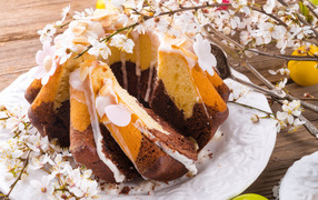 Delicious Easter cake with a flowering branch of the outline on the Bright Holiday Easter