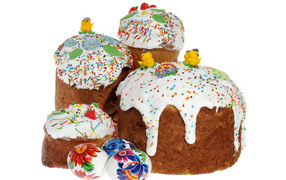 Easter cakes with sugar chickens and painted eggs on a white background
