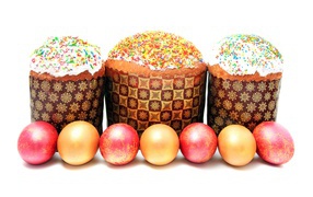 Three Easter cakes with dyed eggs on a white background for Easter holiday