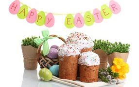 Easter cakes and painted eggs with flowers on a white background for Easter holiday