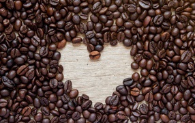 Heart of coffee beans on a wooden table