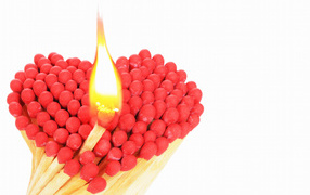 Heart of matches with red sulfur on white background