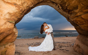 Kiss of the bride and groom against the sea