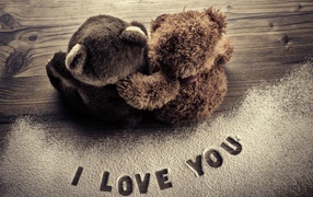 Two teddy bears on the background of the inscription I love you
