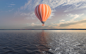 Big balloon over the sea in the blue sky
