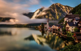 City of Hallstatt over the misty lake in the Alps, Austria