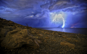 Lightning in the sea pierces a stormy sky