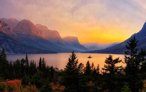 Mountains, lake and coniferous forest at dawn, Glacier National Park, USA