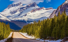 The road against the backdrop of snow-capped mountains, Banff National Park. Canada