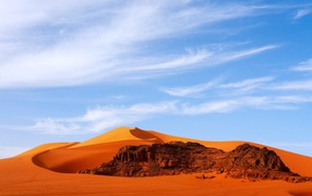 Orange hot Sahara desert under the blue sky