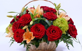 Basket with flowers of a red rose and lilies