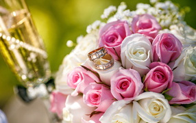 Bouquet of pink and white roses with wedding rings