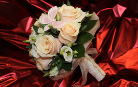 Delicate wedding bouquet with flowers of pink rose and eustoma on a red background