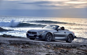 Silver BMW Z4 convertible on the background of the ocean