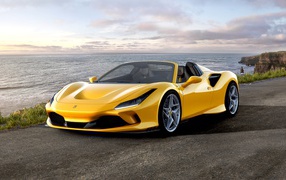 2019 yellow Ferrari F8 Spider convertible by the ocean
