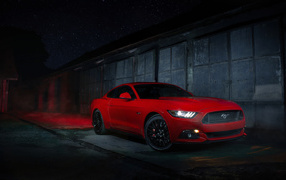 Red Ford Mustang near the wall at night