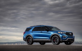 Blue car Ford Explorer on the background of a stormy sky
