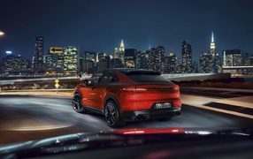 Red SUV Porsche Cayenne Coupe 2019 on the background of the city