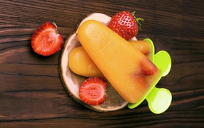 Popsicles on a table with strawberries