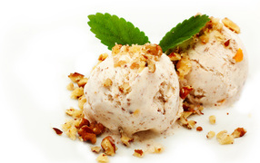 Two balls of ice cream with nuts on a white background