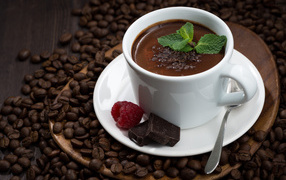Чашка горячего шоколада на столе с кофейными зернами