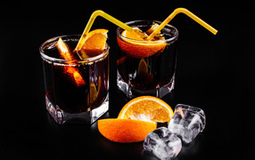 Cocktail with orange slices on a black background with ice