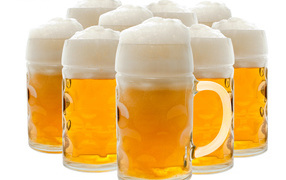 Many glasses of foamy beer on a white background