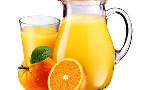 Orange juice on a white background with orange fruits