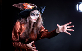 Girl in witch costume for the holiday of halloween