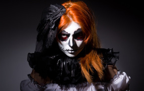 Redhead girl with Halloween facial mask