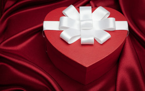 Big beautiful red heart-shaped box with white bow