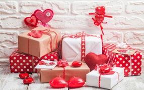 Many gift boxes with hearts on the background of the wall