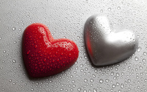 Red and gray heart on a gray background in drops of water