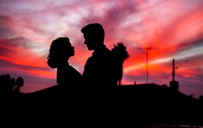 Silhouettes of a couple in love against the night sky