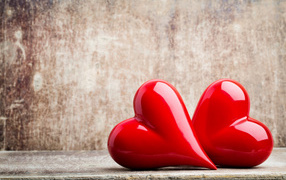 Two bright red hearts on a gray background