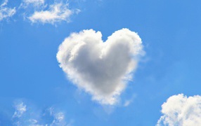 White cloud in the shape of a heart in the blue sky