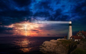 A lighthouse by the sea illuminates a stormy sky