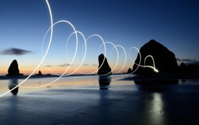 Bright light wave over wet sea sand