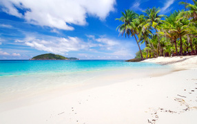 White sand on a tropical beach with blue water