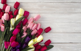 Bouquet of artificial tulips on a gray wooden surface