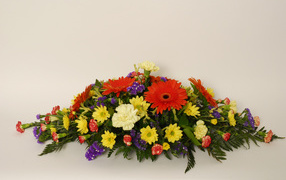 Bouquet of different colorful flowers on a gray background