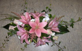 Bouquet of pink lilies with roses on the floor