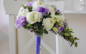 White buttercups and violet eustoma flowers in a bouquet