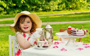 Little girl drinks tea in nature