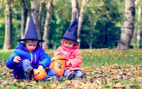 Маленькие мальчик и девочка в лесу на Хэллоуин 