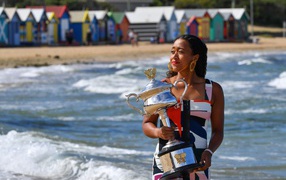 Japanese tennis player Naomi Osaka with a cup at the sea