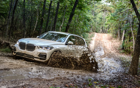 BMW X5 SUV rides through the mud