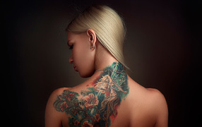 Beautiful tattoo on the back of the girl blonde